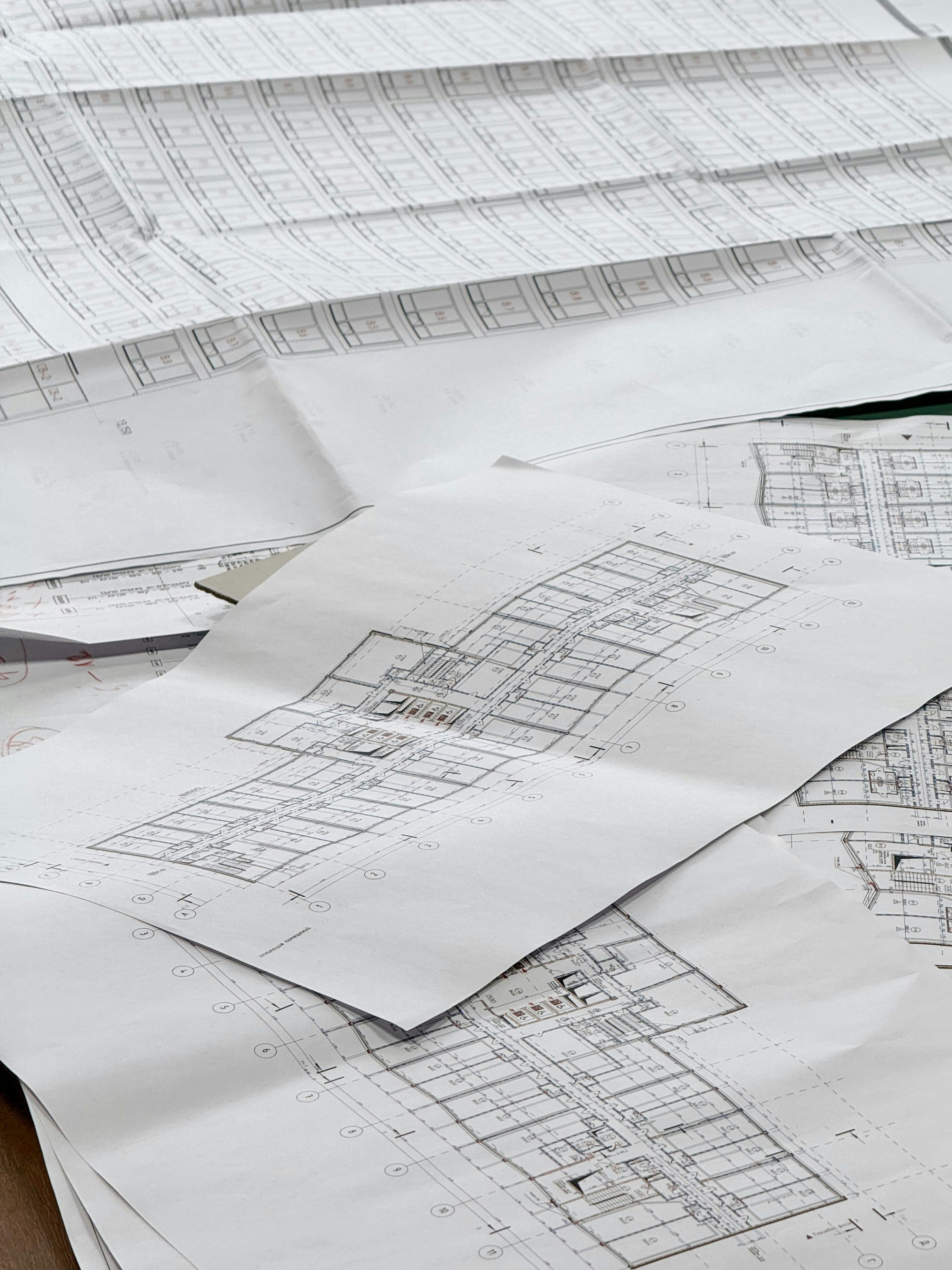 Architectural blueprints spread across a work surface for technical review.
